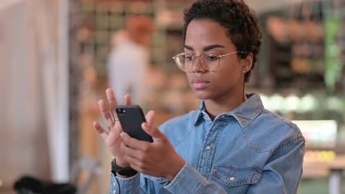 Young Woman Using Smartphone Indoors