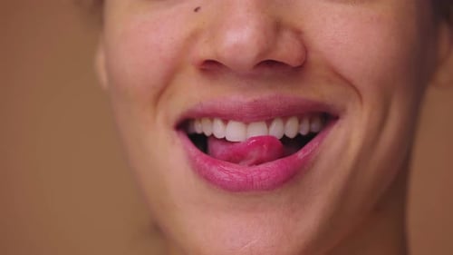 Close Up Macro Portrait of African American Woman Licking Her Lips with Tongue and Biting Her Lower