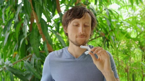 Young Man Shows a Mouth Guard for Protecting Teeth Against Abrasion