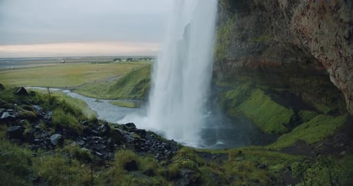 Rear View of Seljalandfoss Waterfall Iceland in Sunset Light