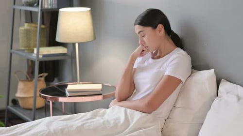 Sleepy Young Latin Woman Taking Nap in Bed