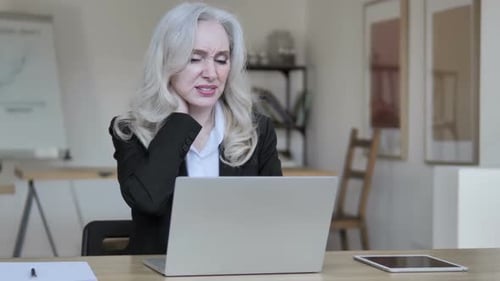 Tired Businesswoman with Neck Pain Working on Laptop