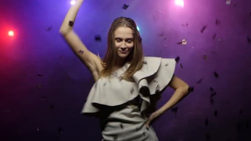 Woman Dancing with Confetti at Night Party