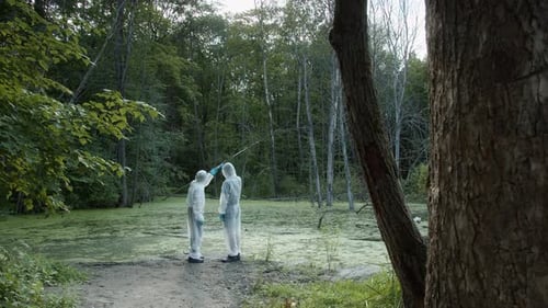 Figures in Suits Stand Next to Bog