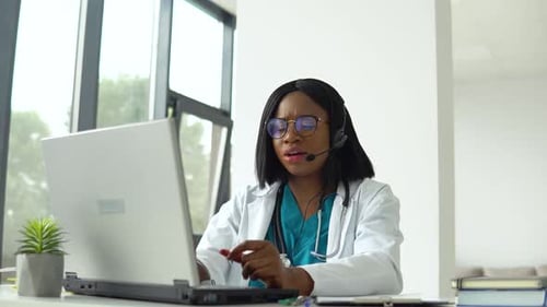 Woman Doctor Engaged in Telehealth Video Call