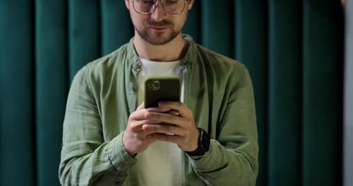 Close Up of Man Using Smartphone and Smiling