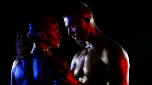 Intimate Couple in Dark, Dramatic Lighting