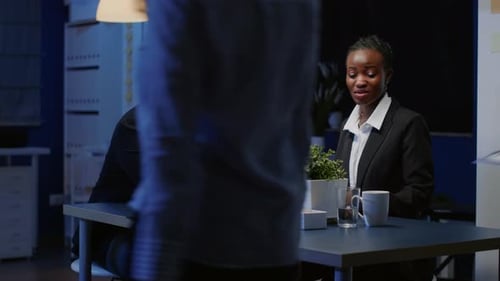 Team Collaborates in Modern Office at Night