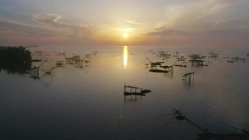Local fishing trap net in canel, lake or river at sunset. Nature landscape fisheries and fishing