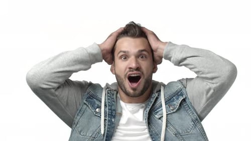 Surprised Young Man Reacting to Good News