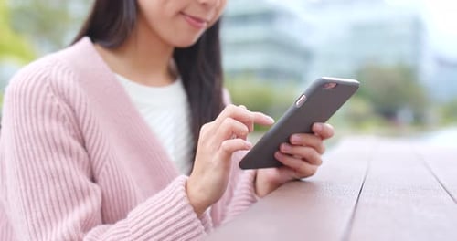 Woman Using Smartphone in Urban Environment