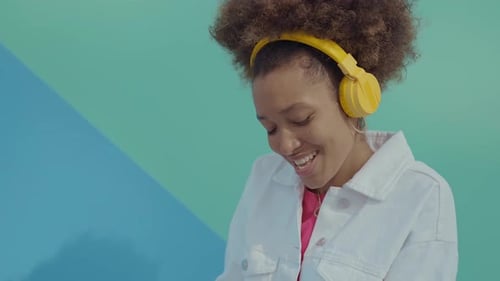Youthful Woman Grooving to Music in Studio