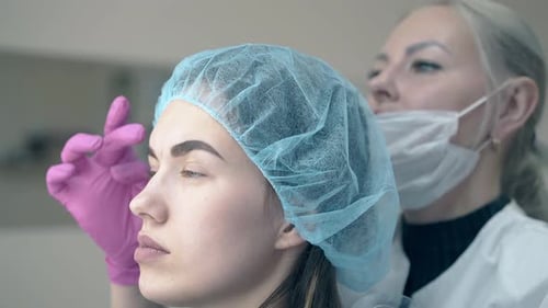 Cosmetologist Working on Eyebrows