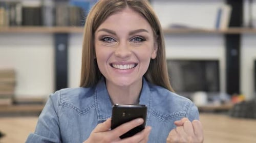 Woman Reacts to Exciting News on Her Phone