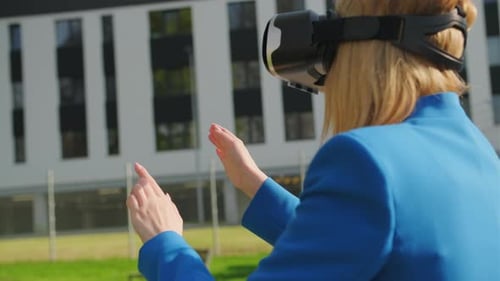 Woman Uses VR Headset in Urban Environment
