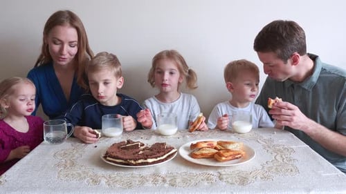 Family Enjoys Birthday Cake Together at Table