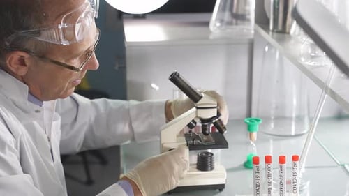 Scientist Using Microscope in Laboratory for Research