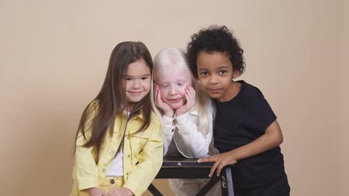 Three Cute Children Posing Together in Studio