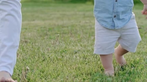 Curious Toddler Walking Barefoot on Grass