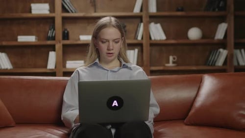 Young Adult Closes Laptop on Couch