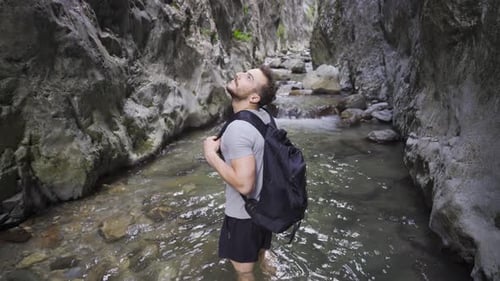 Young mesmerized in the rocky canyon.