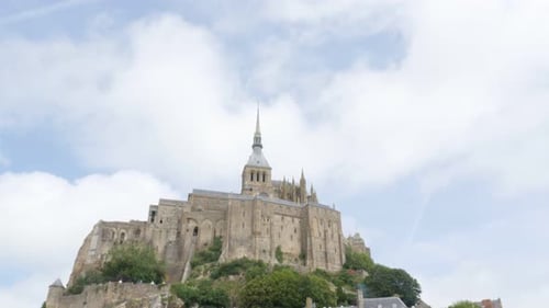Beautiful Mont Saint Michel by the day in Normandy France 4K 3840X2160 UHD slow tilt video - Abbey