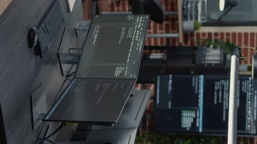 Vertical Video Computer Screens Running Programming Code in Empty Software It Agency Office and