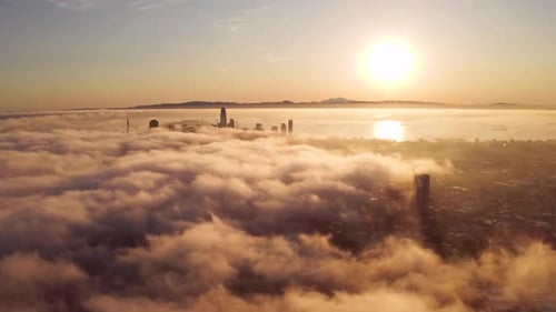 Golden Cityscape Sunrise Above Coastal Fog