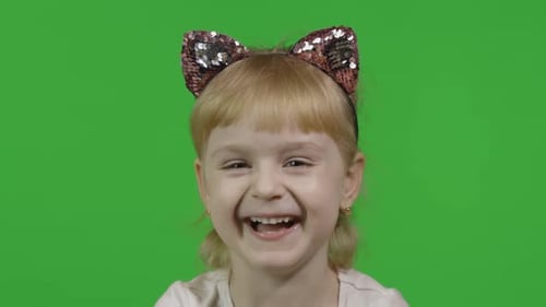 Girl in Cat Headband Laughs Loudly. Happy Four Years Old Child. Chroma Key