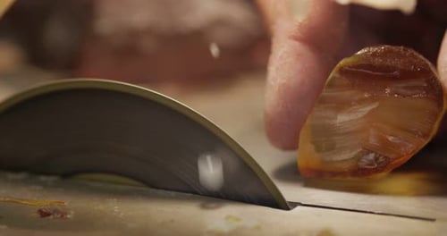 Lapidary Saw Cutting Orange Mineral Rock