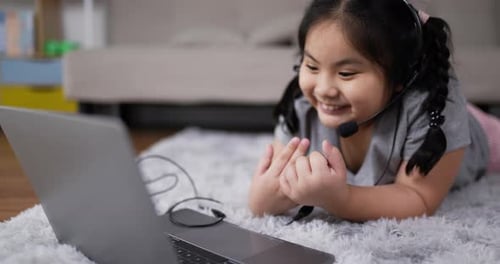 Girl Smiles Video Chatting on Laptop at Home