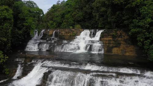 Beautiful Waterfall Cascades Through Tropical Green Landscape