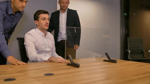Men Discussing Futuristic Technology in Office Meeting