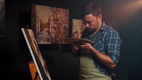 Caucasian Man Artist Painting a Picture in Art Studio