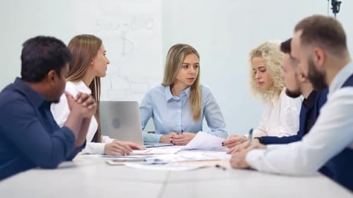 Group of Smiling Multiethnic Business People Having Team Meeting and Brainstorming at Modern Office