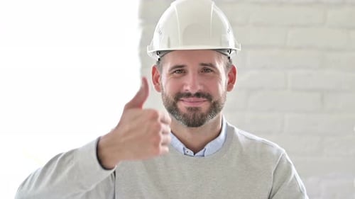 Portrait of Positive Young Engineer Doing Thumbs Up