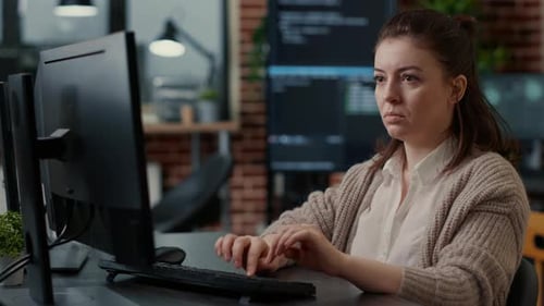 Database Programer Working Focused Looking at Computer Screen While Typing