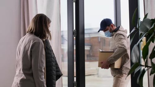 Delivery Man Delivers Package To Woman