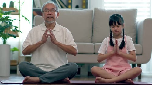 Gray Haired Man and Child Practicing Yoga