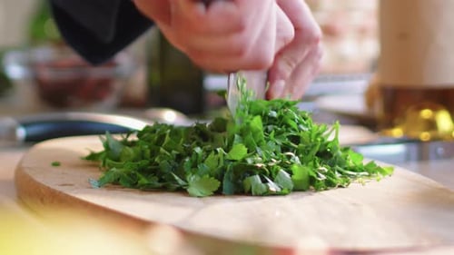 Chopping Parsley with Knife on Cutting Board