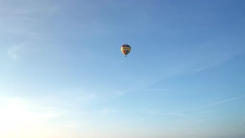 Hot Air Balloon Drifting Through Blue Sky