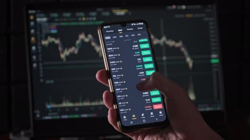 Hand Scrolling on Phone with Stock Chart Background