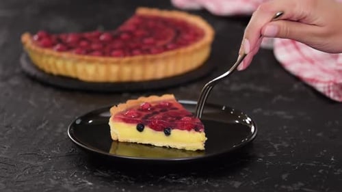 Delicious Berry Tart Slice Being Enjoyed