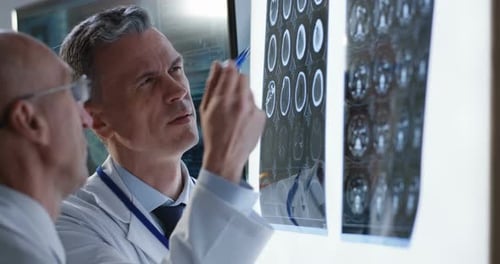 Doctors Analyzing Result of a Brain Scan