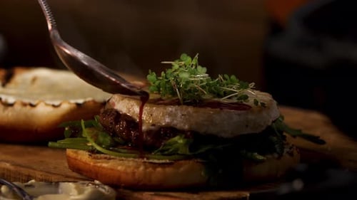 Gourmet Burger Preparation with Cheese and Sauce