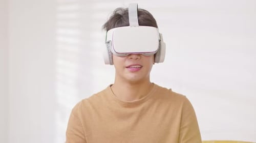 Young Adult Using VR Headset Interacting Virtually