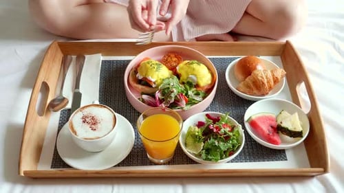 Lavish Breakfast in Bed with Eggs Benedict and Cappuccino