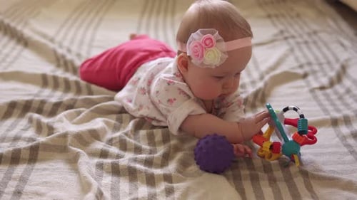 Adorable Baby Playing With Toys on Blanket