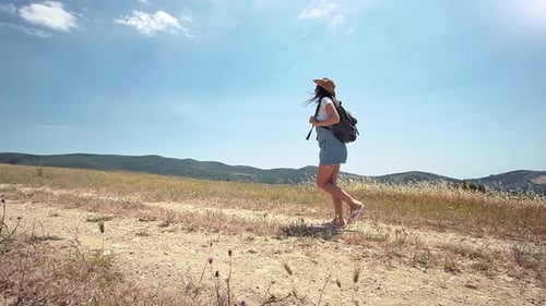 Side View Active Female Traveler on Hiking Trail at Dry Grass Tracking Shot