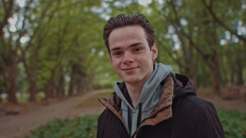 Young Happy Man Looks To the Camera. Happy Smiling Male Face, Outdoors. Close Up